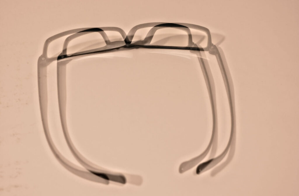 A close-up of a pair of blurry glasses