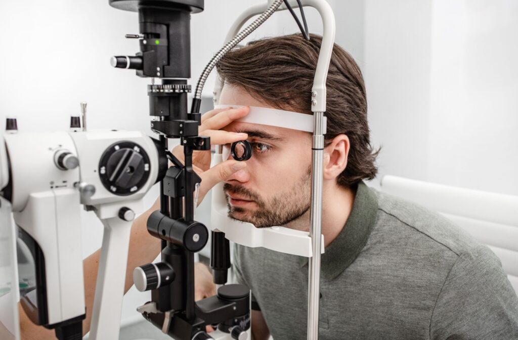 A patient receives an eye examination in a bright clinical setting.