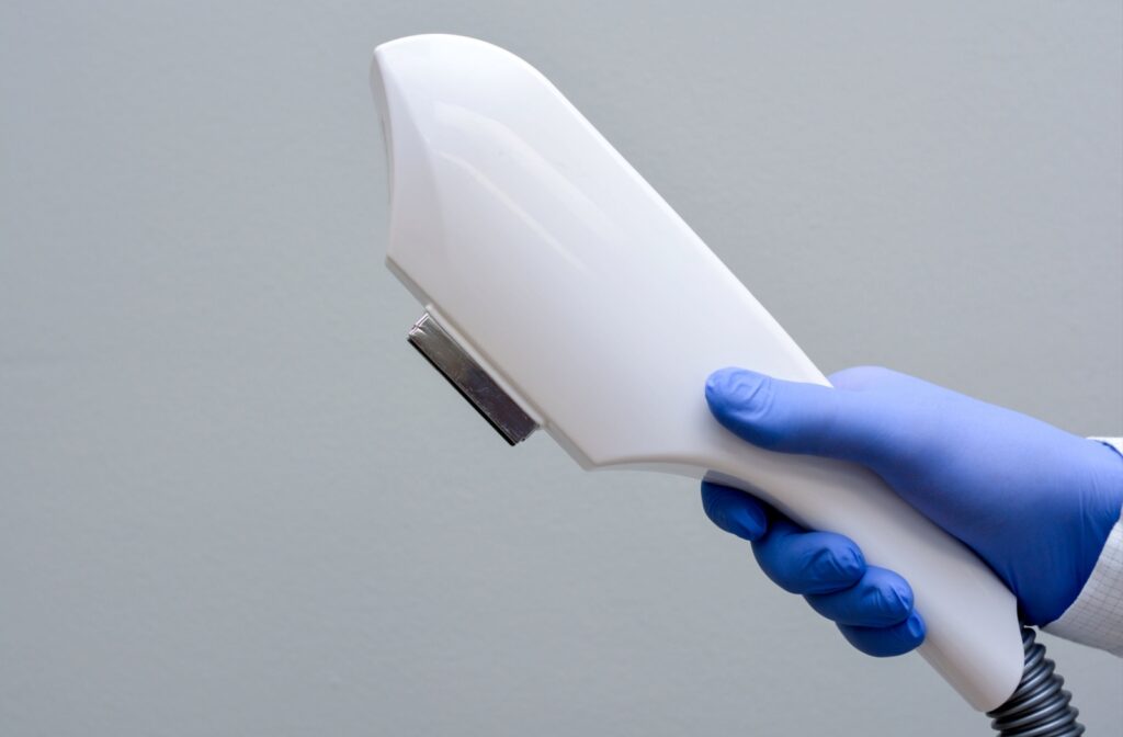 A close-up image of a hand holding an intense pulsed light tool.